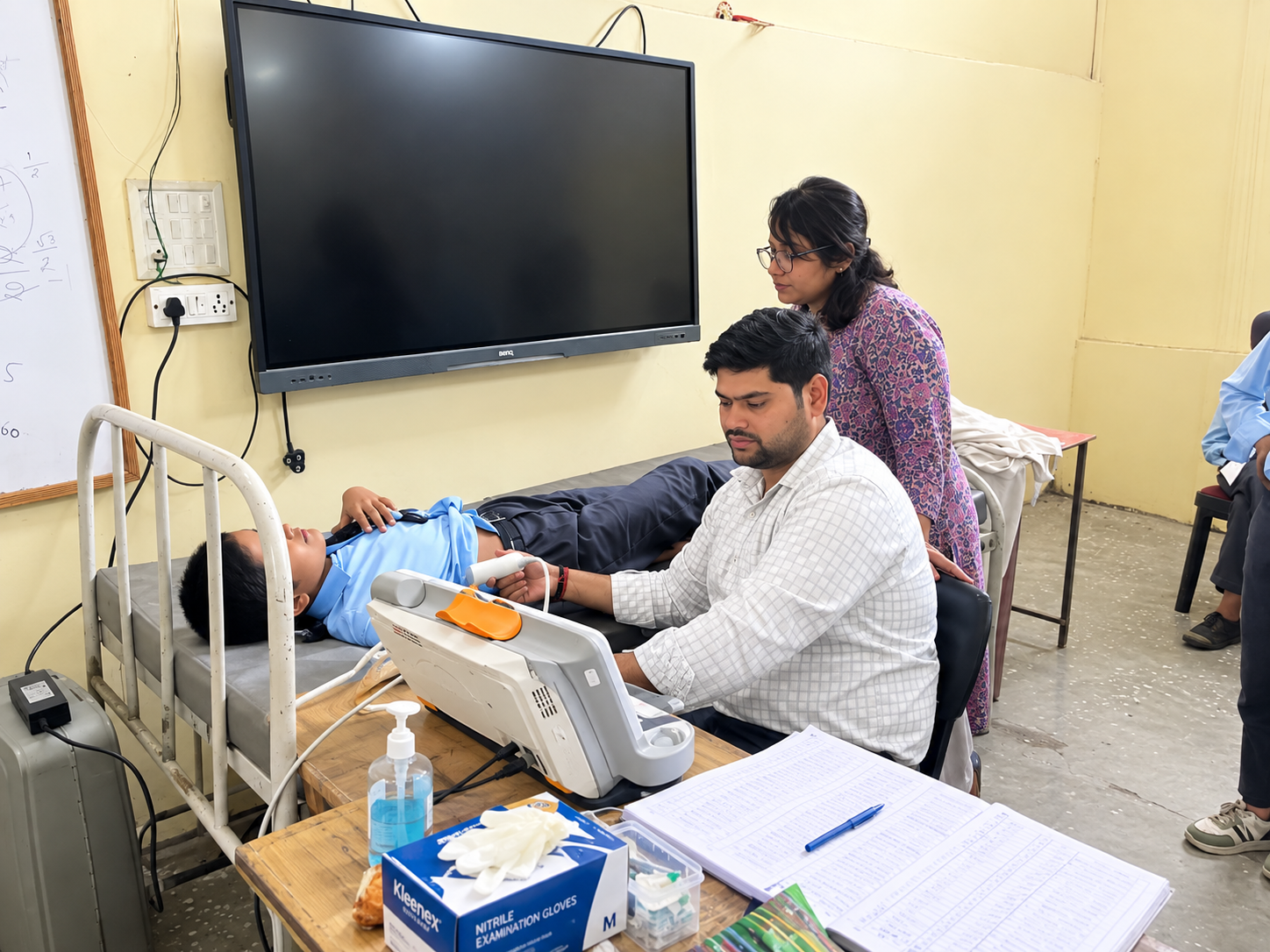 A student receiving a health screening at a community wellness event